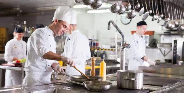 Chefs using catering kitchen equipment